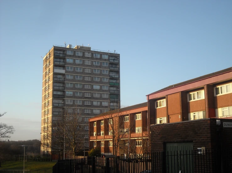 two large brown brick buildings next to each other