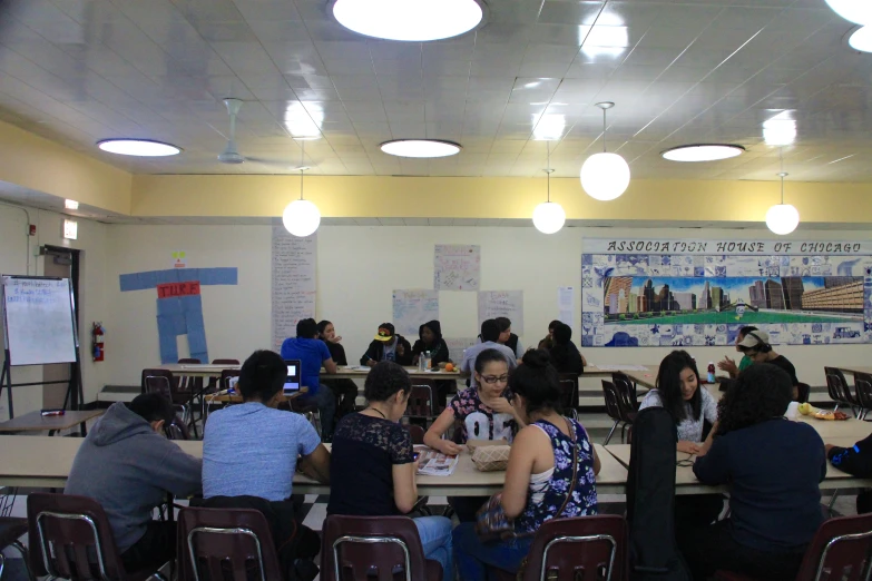 a group of people that are sitting at some tables