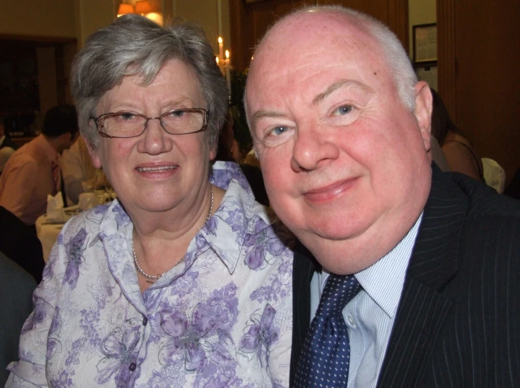 a couple sitting next to each other at a formal event