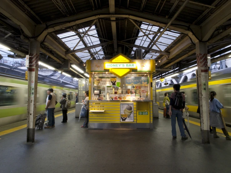 a train station with people waiting and people waiting