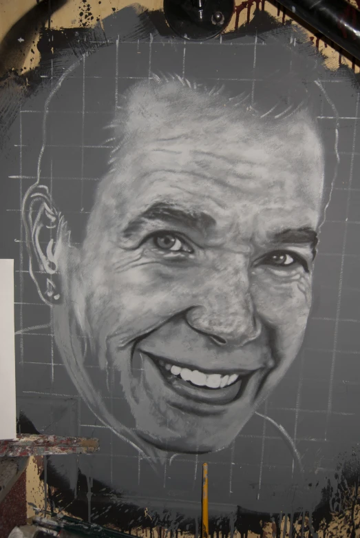 there is a large chalk drawing of a man smiling