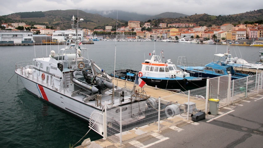 the tug boat sits docked in a marina