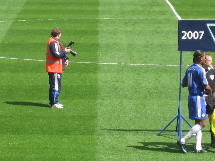 two soccer players walking towards the goal post