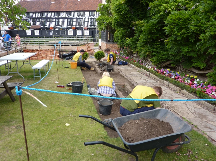 people are building landscaping beds in a yard