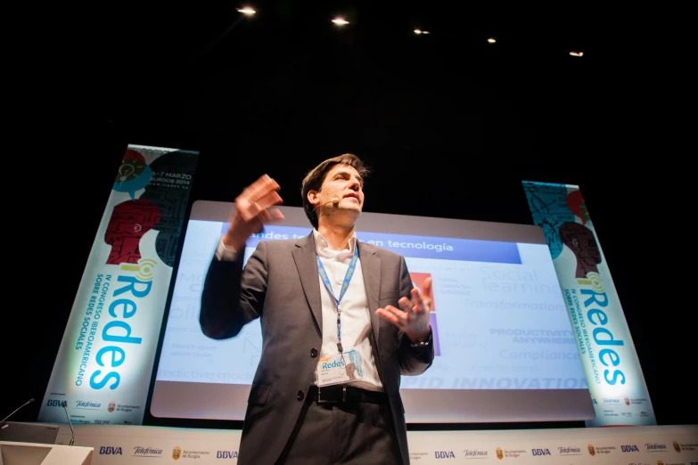 a man is giving a presentation with his hands