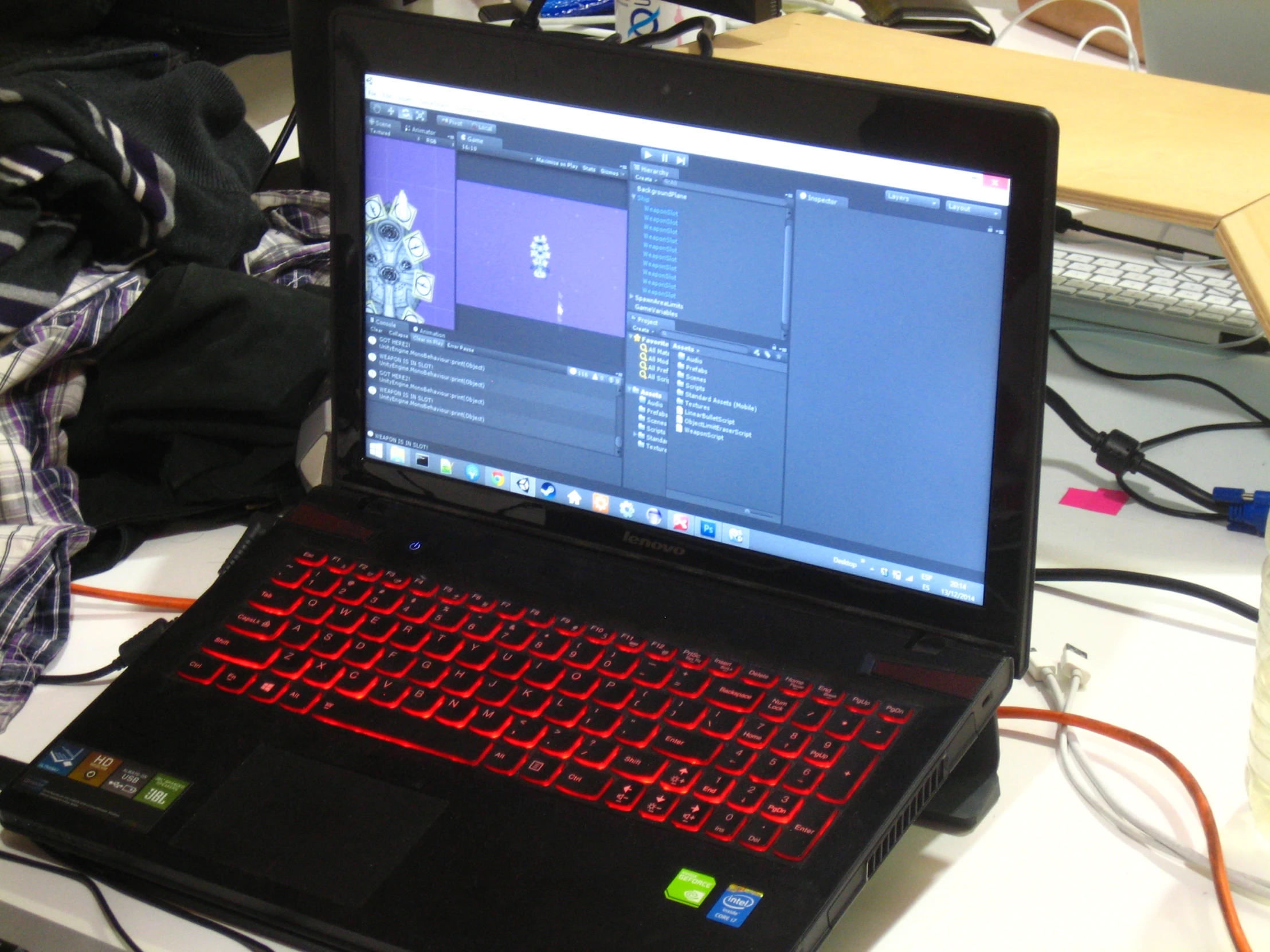 a laptop sitting open on a desk with the screen lit up