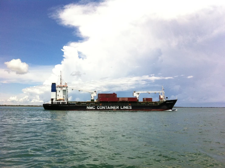 a cargo ship is moored off on a lake