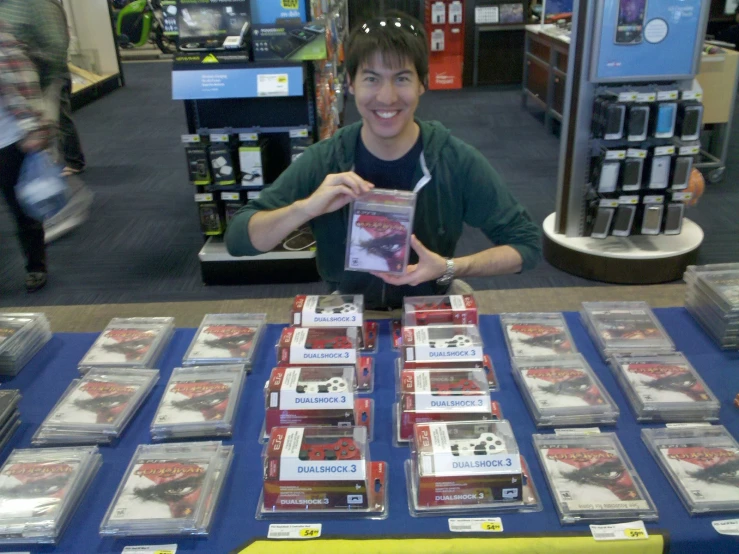 a person in a store holding up a card