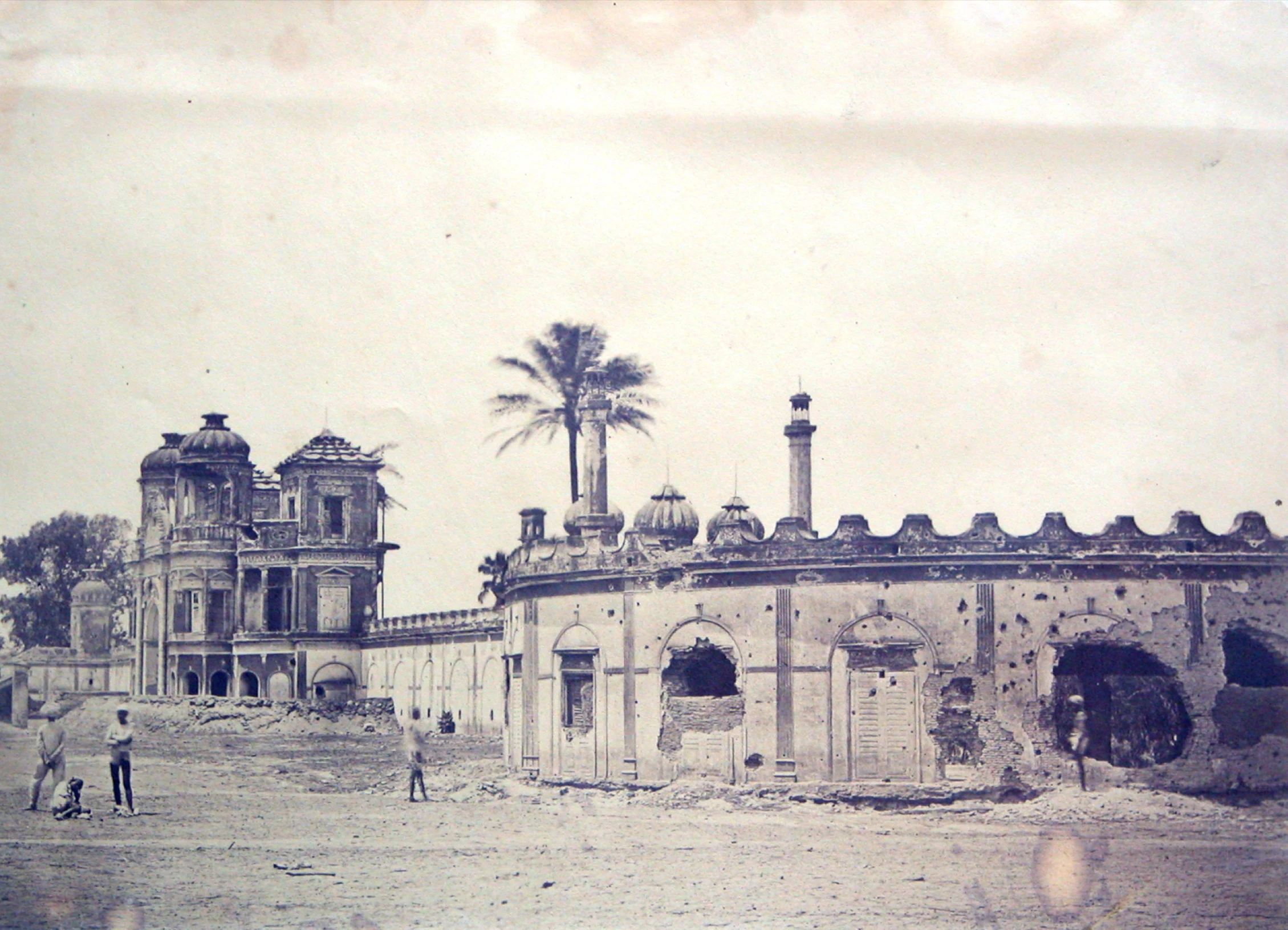 an old black and white po of some people standing by a building