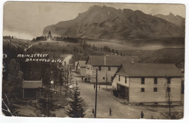 old pograph of an alpine town with a church on the top of a mountain