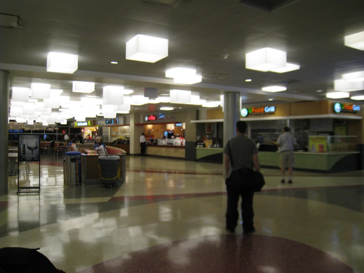 a few people at the airport looking for their luggage