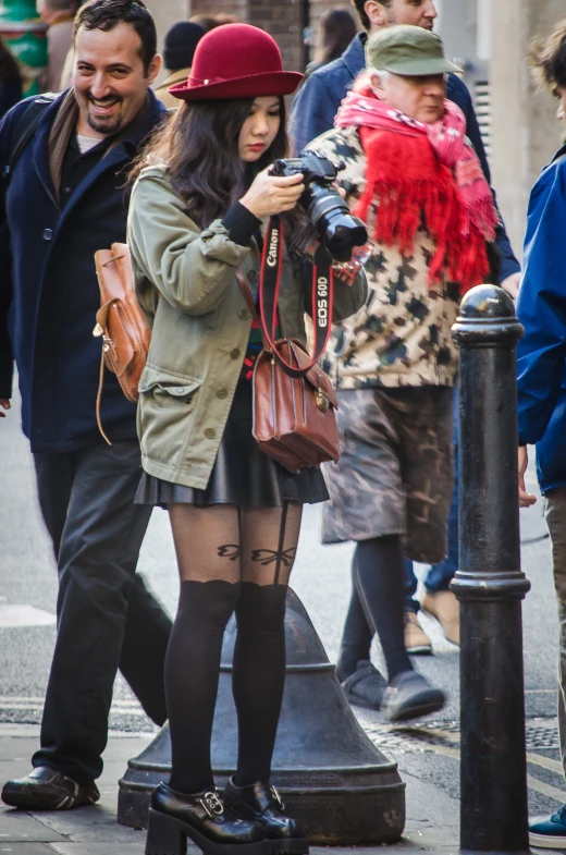 two people standing next to each other near a street