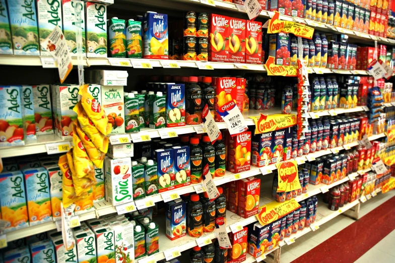 a shelf of various foods and juices on display