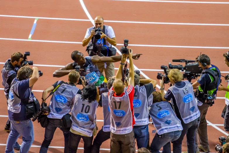 a man holding onto his camera on top of a field