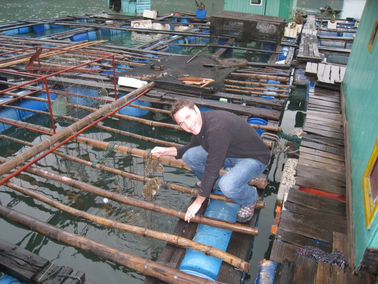 a man stands on a raft in a body of water