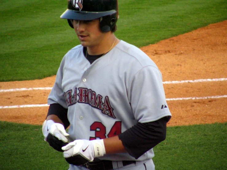 a baseball player with a glove is standing in front of the batter