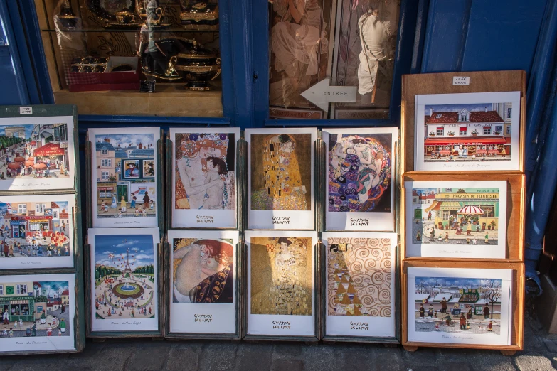 many books displayed on an outdoor stand with artwork