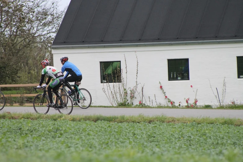 two men wearing bikes are passing each other