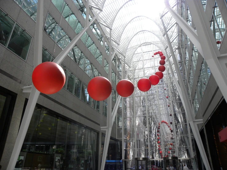 a building with large red balls in the middle of the floor