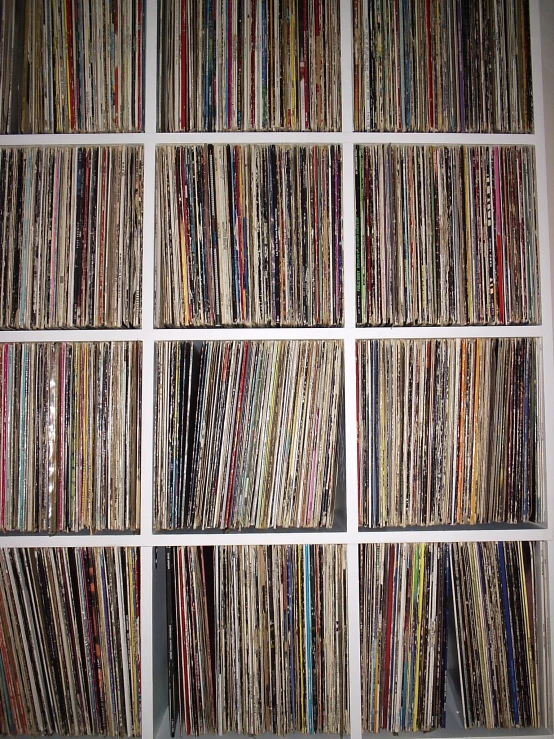 a large collection of vinyls are stacked neatly