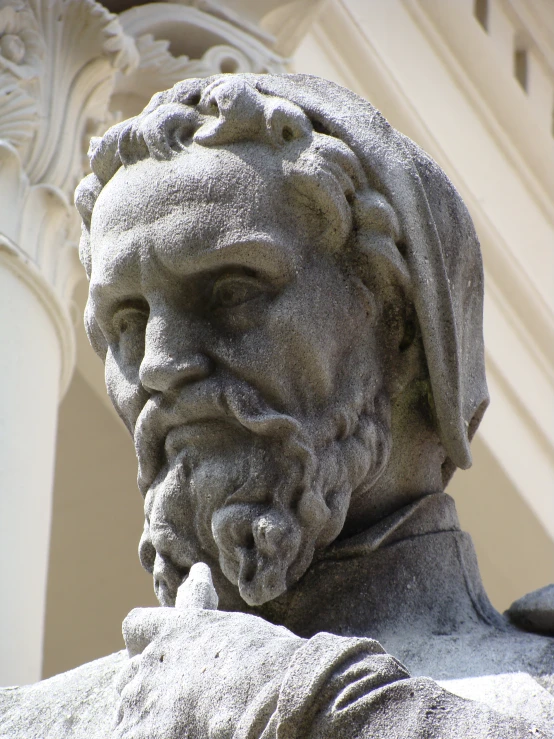 closeup of the head and shoulders of an old statue
