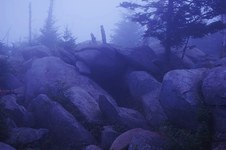 some large rocks on the side of a mountain