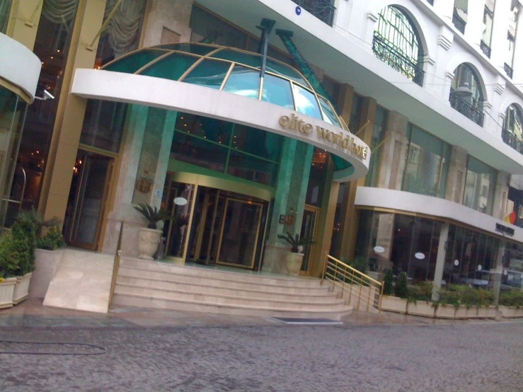 a large green and white building that has a round doorway