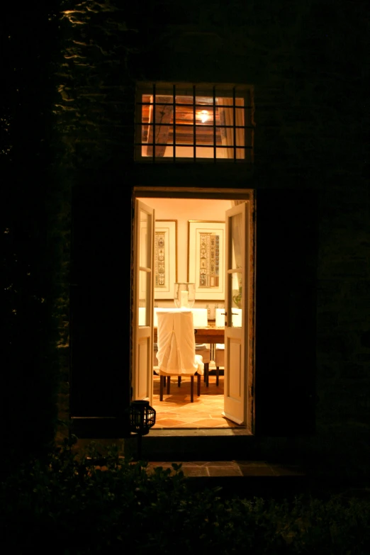 an open door that shows a table and chair