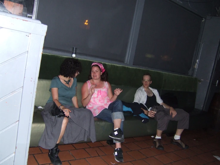 a group of people sitting down on top of a couch