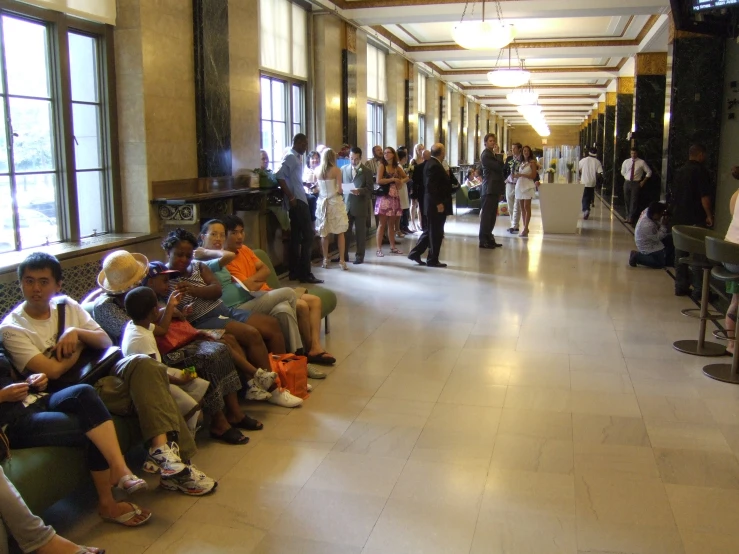 a crowd of people waiting for their train