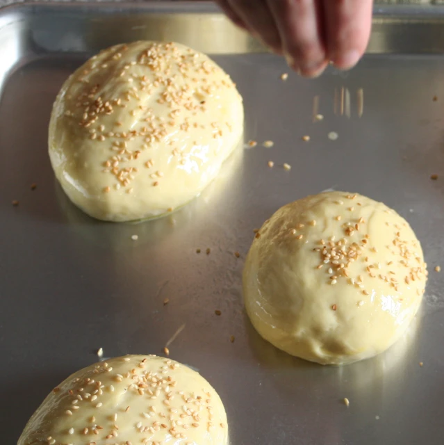 three buns in a pan with sprinkles on them