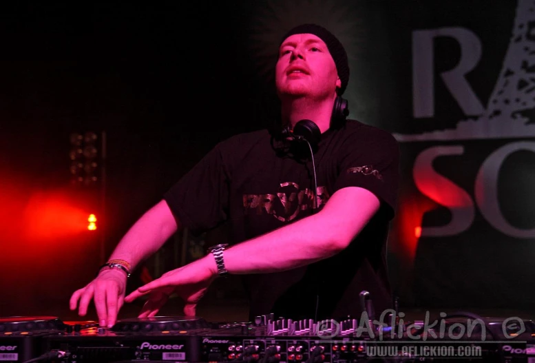 a man at an event mixing music on his turntable