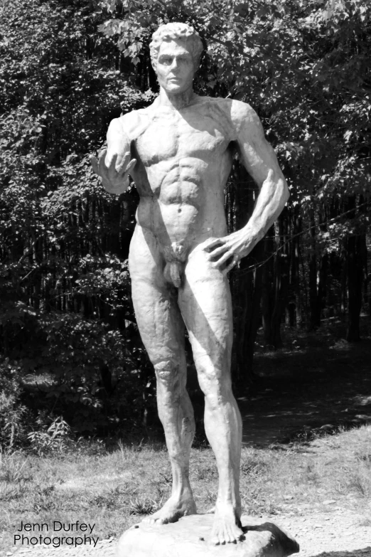 a male  figure with  on standing next to trees