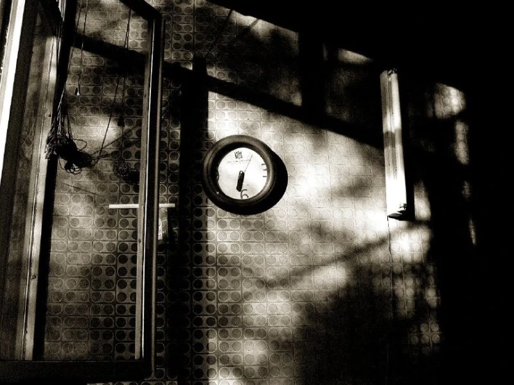 a bathroom area with shower, bathtub and wall clock