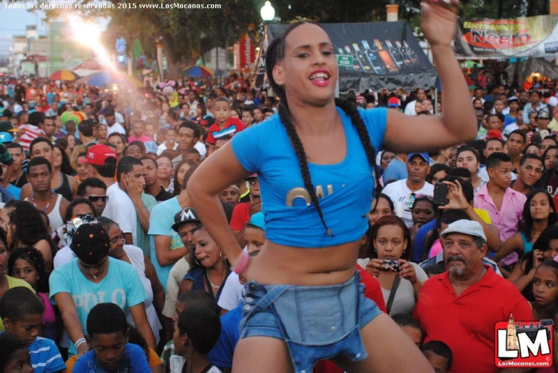 a lady with her cell phone standing in front of a crowd