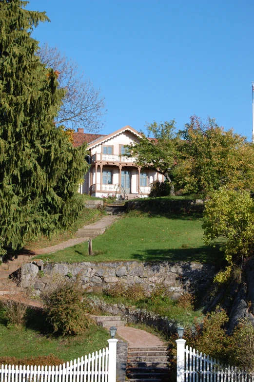 an image of a home with a hill in the background