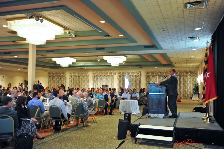 a man standing at the podium delivering a speech