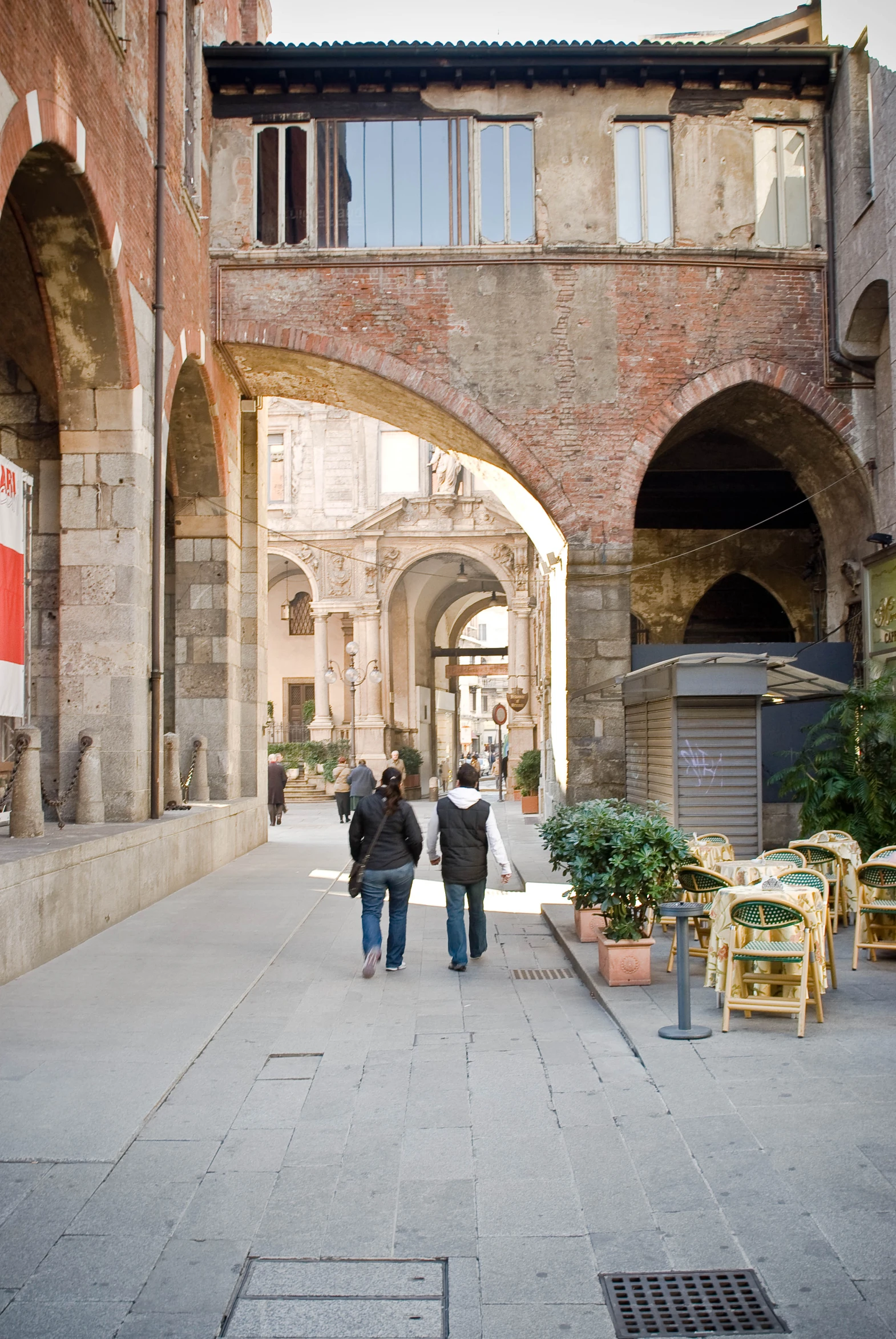 there is a woman and man walking down a street