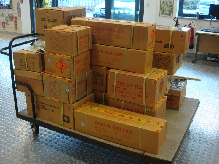 some boxes are stacked on a pallet near a window