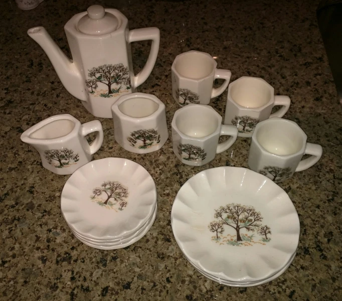 a bunch of dishes that have cups and saucers on them