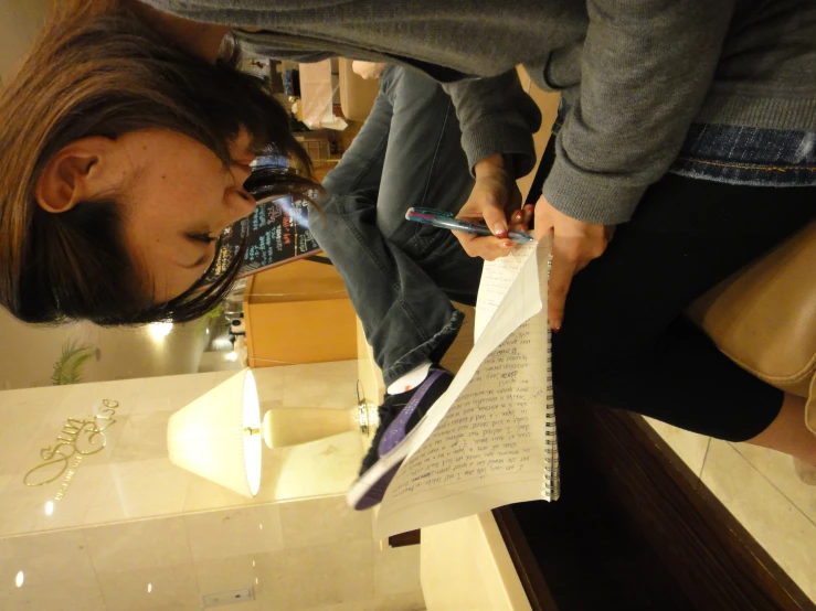 young woman writing a book in her living room