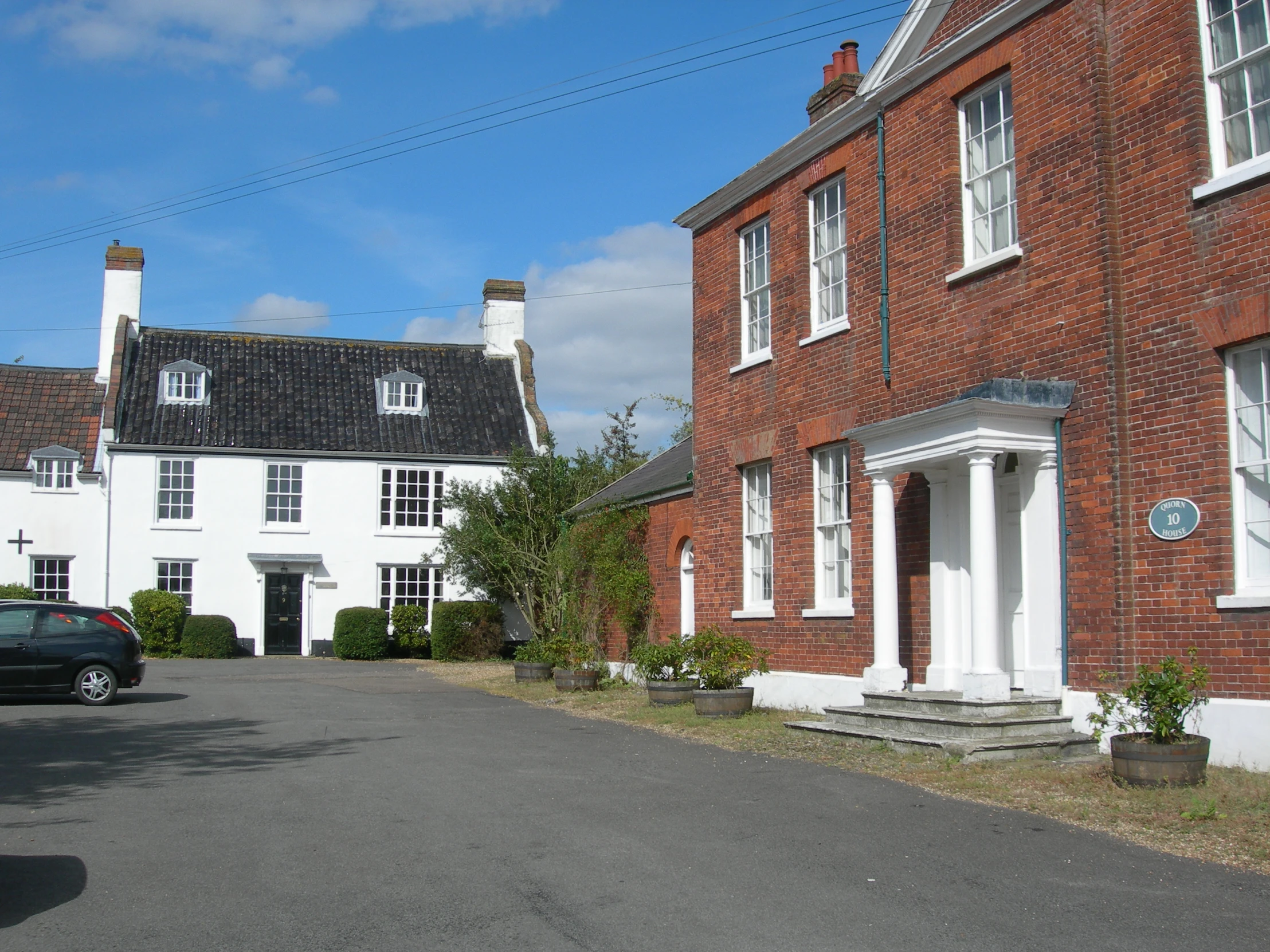 a red brick building with two stories and an entrance