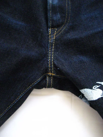 sewing the pattern on the bottom half of the jeans