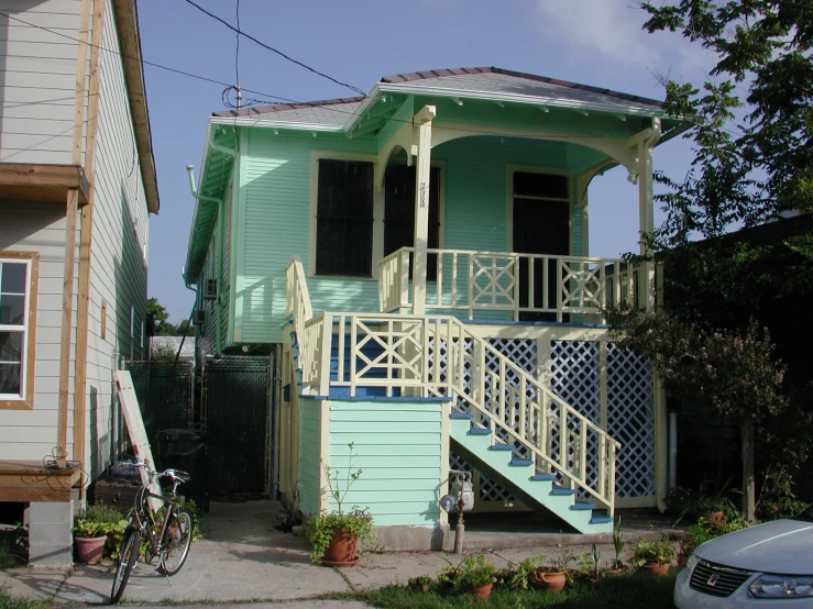 blue house with white stairs, green front door and stairs