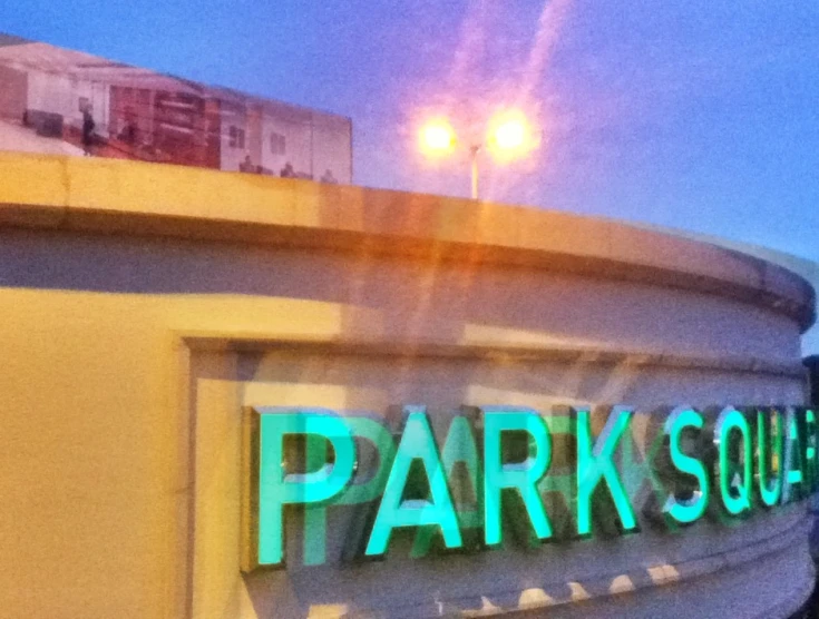 the dark side of a parking garage with an outside sign