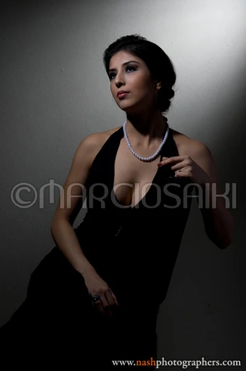 an attractive woman posing for a camera with a necklace on
