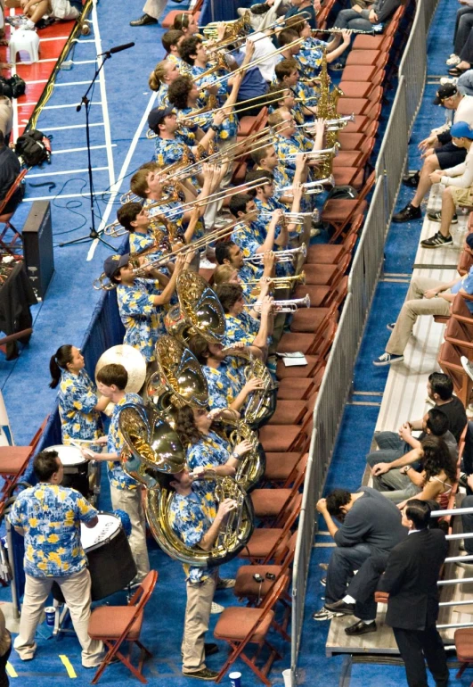 marching band holding up large instrument at competition