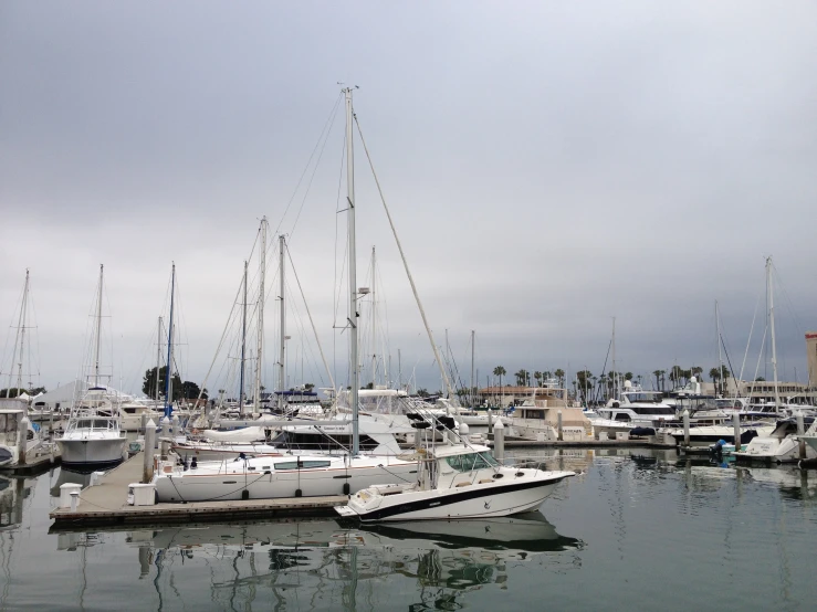 several sailboats moored at a marina in a town