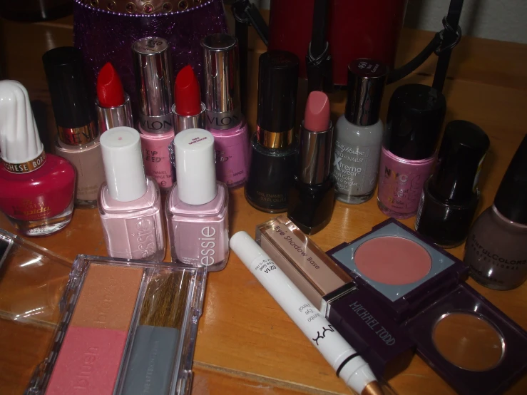 a close up of many different kinds of makeup on the table