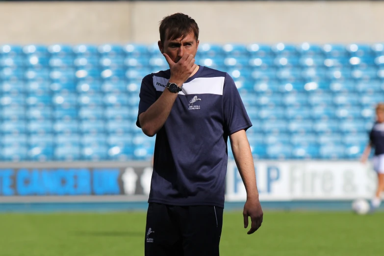 a soccer player is looking sad while on the field